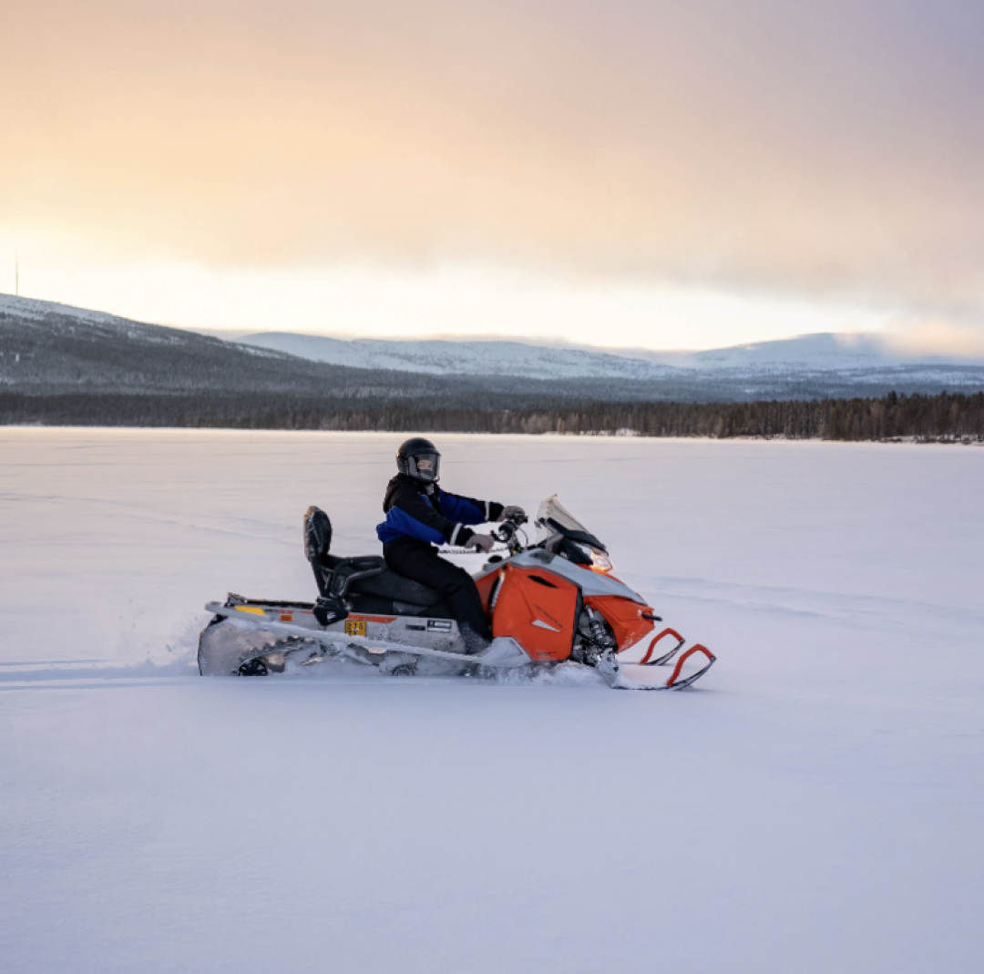 Snowmobile and the driver on a beautiful winter day on Pyhäjärvi ice