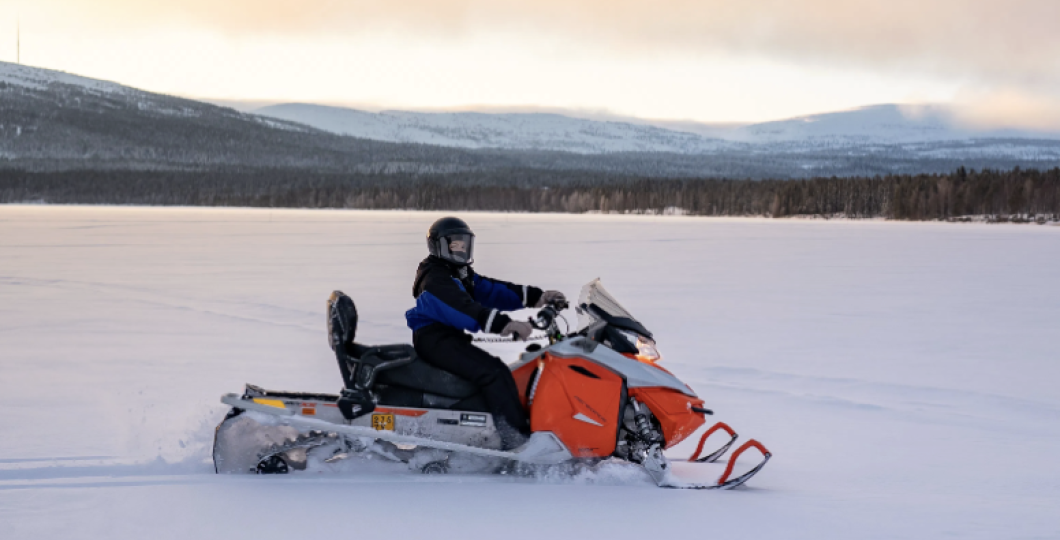Snowmobile and the driver on a beautiful winter day on Pyhäjärvi ice